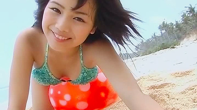 Rion Sakamota plays with a ball on the beach