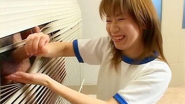 Kinky Asian schoolgirl gives handjob in the classroom