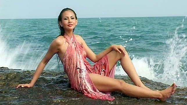 Alluring and hot brunette is showing her tits in the water