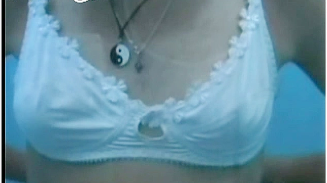 Adorable and ty babe in white bra is showing her hooters