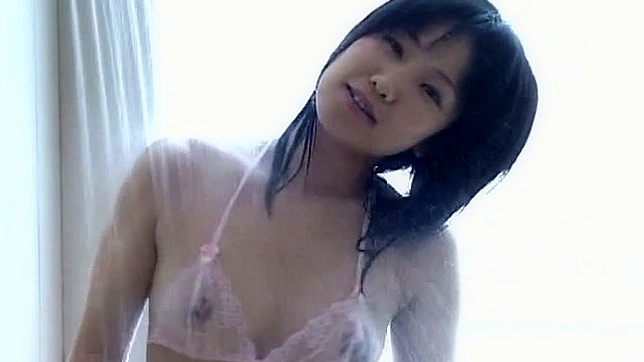 Dark haired and japanese teen is taking shower outdoors