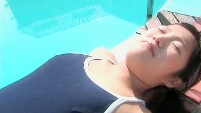 Pretty Japanese chick shows off her fat pussy print in her swimsuit